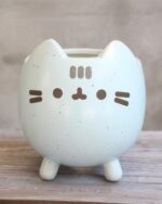 Cute pusheen flower pot, light blue ceramic design with paw details.