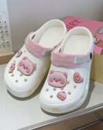White Piggy Crocs with pink and red details, featuring a cartoon pig design.