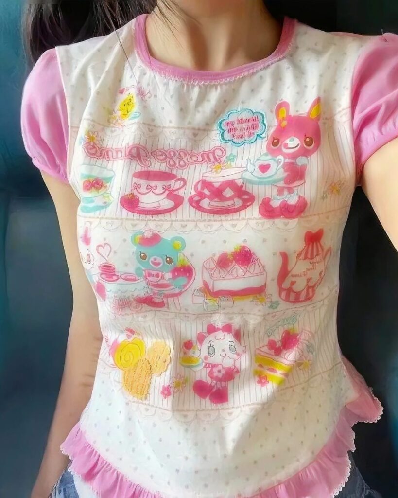 Kawaii Cake Shop Tee featuring cartoon cakes, bears, and bunnies on a white background.