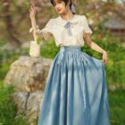 Blue cottagecore aesthetic dress with ruffled skirt and lace details.