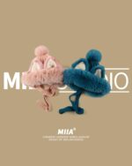 MIAA fox ears hat in pink and teal, a winter headwear accessory.