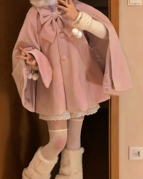 A pink lolita hooded coat layered with a white dress and accessories.