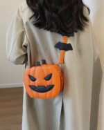 Cute orange pumpkin halloween bag with black bat accents, crossbody style.