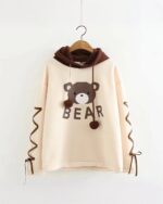 Kawaii kuma bear hoodie featuring a bear graphic and 'BEAR' text on a light pink sweatshirt.