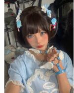 Close-up of a person wearing winged love bracelets, part of a Harajuku aesthetic outfit.