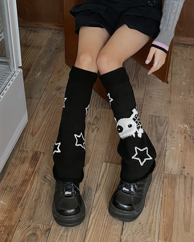 Black gothic gyaru leg warmers with skull and star pattern, covering lower legs.