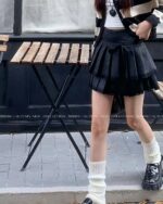 Black laced pleated korean aesthetic skirt worn by a person.