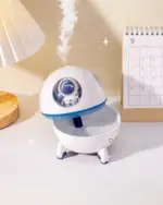 Kawaii Mini Spaceship Humidifier, an astronaut humidifier, on a wooden surface.