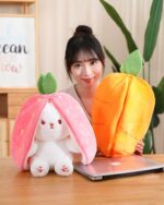 Kawaii transformable bunny plushie – a strawberry and carrot plushie set shown with a woman.