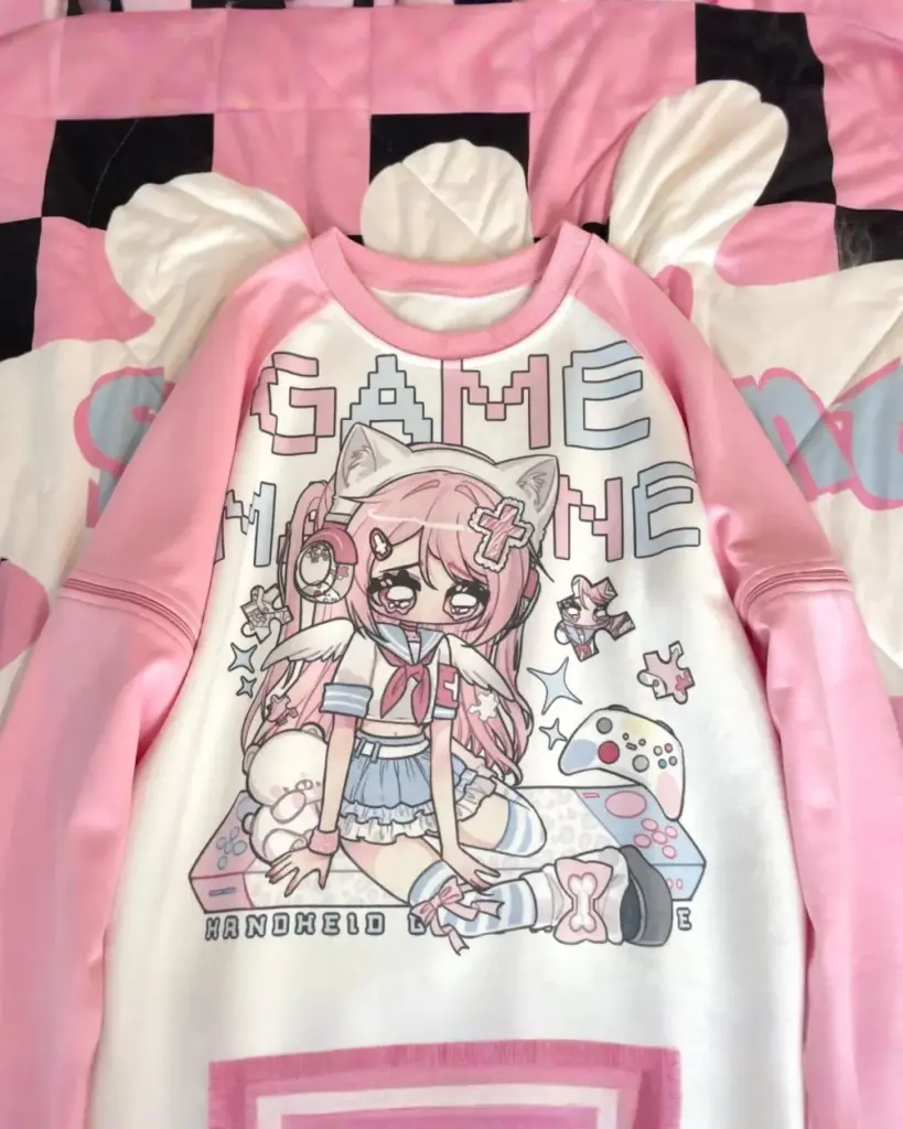 Printed pink kawaii t-shirt featuring a cute anime-style character and "Game Over" design.