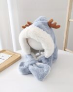 Cute and fluffy reindeer winter hat on a white mannequin head.