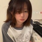 Person wearing an animecore aesthetic shirt with a manga illustration.