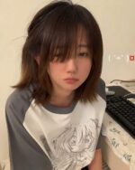 Person wearing an animecore aesthetic shirt with a manga illustration.