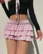Pink ruffled coquette aesthetic skirt with layers, worn by a person.