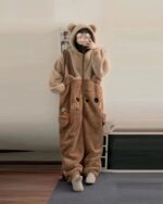 Woman wearing brown bear fluffy pajamas, a cozy kawaii clothes set.