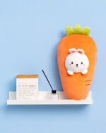 Kawaii food plushie of a carrot with a bunny face, displayed on a shelf.