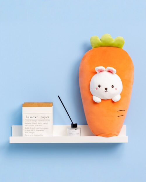 Kawaii food plushie of a carrot with a bunny face, displayed on a shelf.