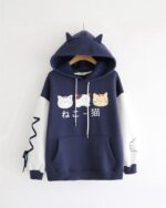 Dark blue neko pullover hoodie with cat illustrations and cat ear hood.
