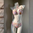 Pink and floral kawaii aesthetic swimsuit, four-piece bikini top and bottom on a mannequin.
