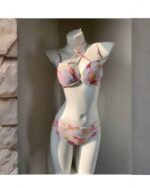 Pink and floral kawaii aesthetic swimsuit, four-piece bikini top and bottom on a mannequin.