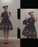 Model wearing a gothic lolita dress featuring a coffin print and sheer overlay.