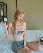 Woman wearing a y2k aesthetic top featuring a cat print, casual style.