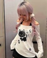 White Patched Neko off-shoulder t-shirt with a cat graphic, long sleeves.