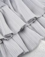 Close-up of a gray ribbed y2k aesthetic skirt with ruffles.