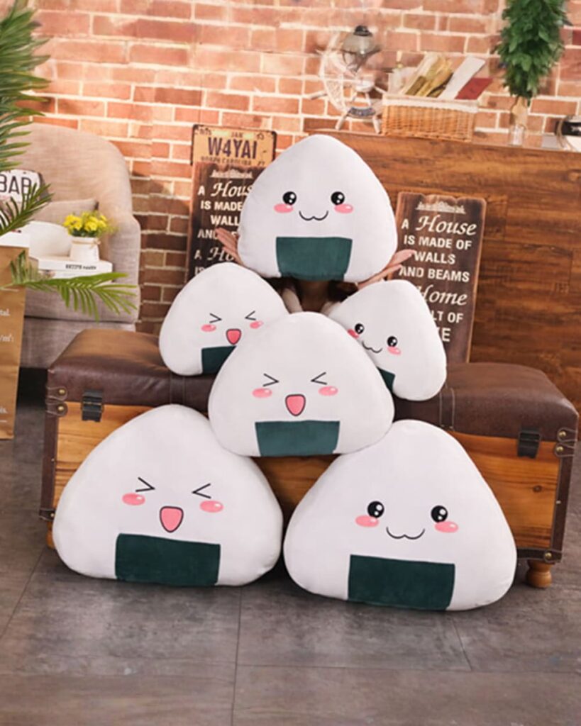 Kawaii onigiri plushies set featuring three smiling rice ball characters with seaweed details.