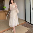 Woman wearing a French Style Long Sleeve Dress, a coquette aesthetic dress, in an outdoor setting.