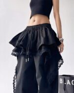 Black y2k cargo pants with ruffle and lace details.