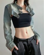 Loose y2k denim top worn by a model, featuring a cropped design and long sleeves.