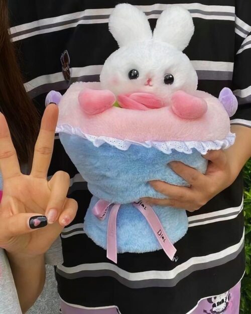 Close-up of a bouquet rabbit plushie featuring a pink and blue design with ruffles and ribbon.