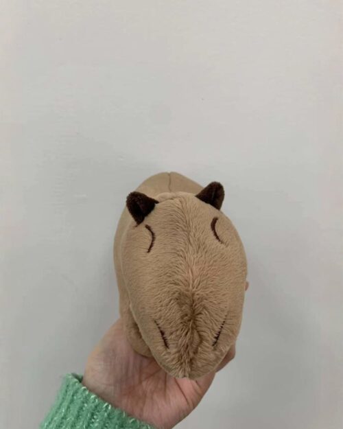 Light brown capybara plushie toy, soft and cuddly.