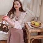 Puff sleeve french aesthetic dress worn by a woman in a cozy room setting.