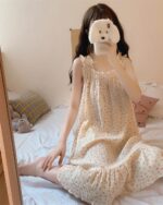 A beige kawaii princess pajamas dress with floral print and ruffle details, worn by a person.