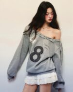 Off shoulder gray sweatshirt featuring a large number 8 graphic. Coquette aesthetic sweatshirt.