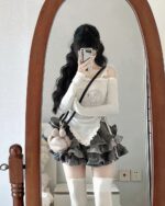 A y2k lolita set featuring a long-sleeved, off-the-shoulder top and layered ruffled skirt.
