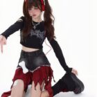 Model wearing a punk plaid denim skirt with red and black plaid detailing.