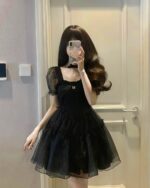 Black aesthetic vintage dress with puff sleeves and gathered skirt.