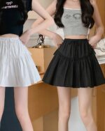 Two women wearing a black and white summer japanese-style skirt with tiered ruffles.