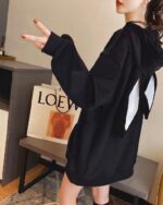 Black bunny ear hoodie worn by a person in an indoor setting.