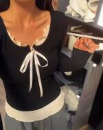 Black vintage aesthetic sweatshirt featuring a lace trim and bow detail.