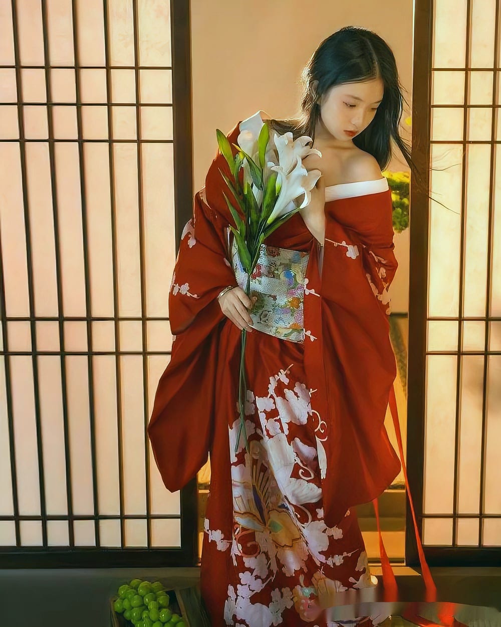 A red aesthetic kimono with floral patterns, worn by a woman indoors.