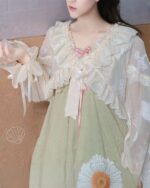 Fairycore sleeve bow, delicate white lace embellishment on a pastel dress.