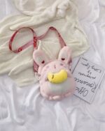 Close-up of a pink chibi loli handbag with a heart design.