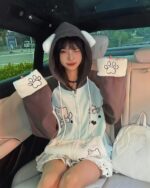 Person wearing a kawaii neko hoodie with paw prints, Harajuku style.