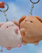 Two kawaii piggy keychain plushies, a couples edition, hang on keyrings.