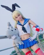 Cosplayer wearing a shimakaze uniform set from Kantai Collection, holding a plush toy.