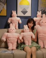 Multiple buff bunny plushies (buff bunny plushie) displayed on a couch.